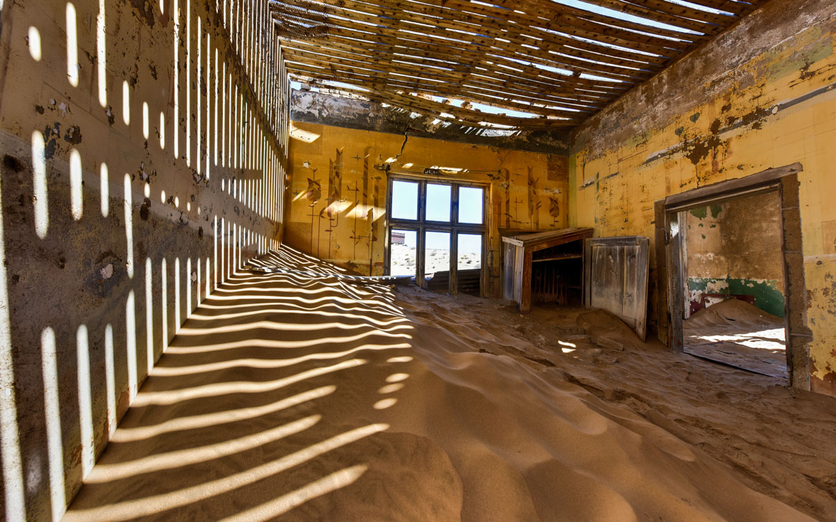The abandoned ghost diamond town of Kolmanskop in Namibia, which is slowly being swallowed by the desert.
